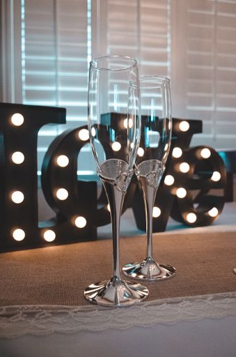 A vertical closeup shot of two champagne glasses on a table