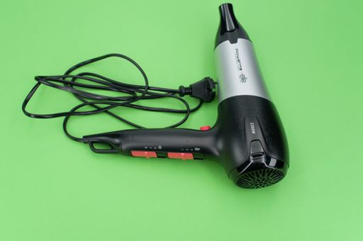 isolated hair dryer on a green background with text space