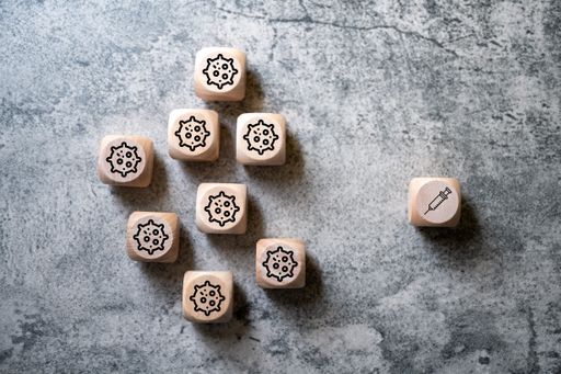 A top view of dices with coronavirus icons
