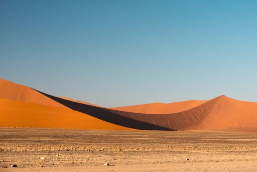 A beautiful picture of Namib National Park dunes against brown sand mountains - Perfect wallpaper for desktop