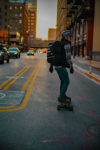 A skateboarder on the road in the morning