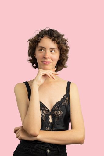 A beautiful mexican girl posing on pink background