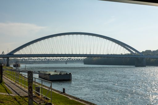 A beautiful shot of a huge bridge over the lake in the daytime.