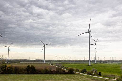 A beautiful shot of many wind generators on the agricultural field.