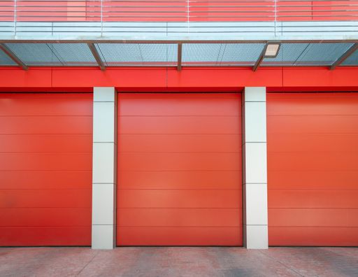 Empty Red metal warehouse with closed roller shutter door