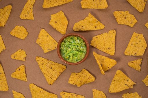 A closeup shot of guacamole with chips