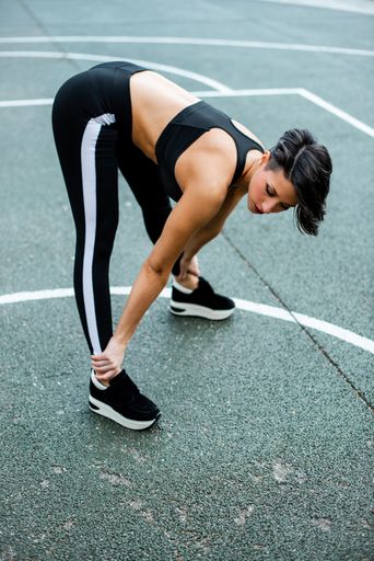 A fit Caucasian female working out outdoors