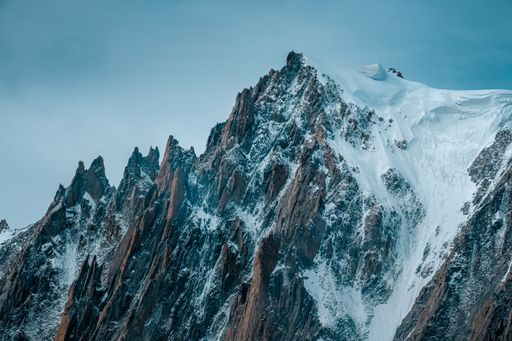A beautiful shot of snowy mountains with a clear sky in the background