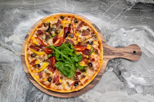 A top view shot of delicious pizza served on a wooden plate