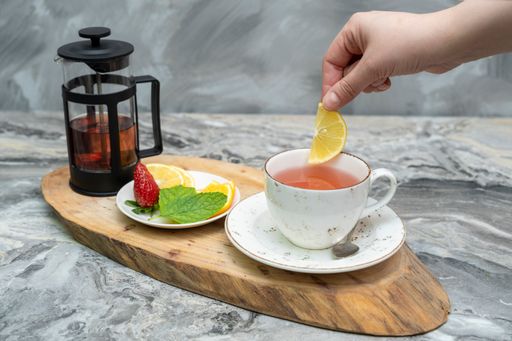 A closeup shot of a herbal tea on a wooden serving platter