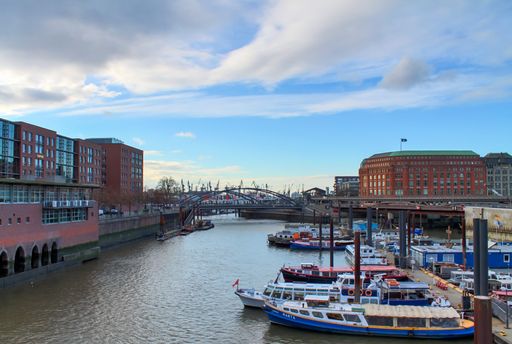 A view over port of Hamburg with small boats and old trade buildings
