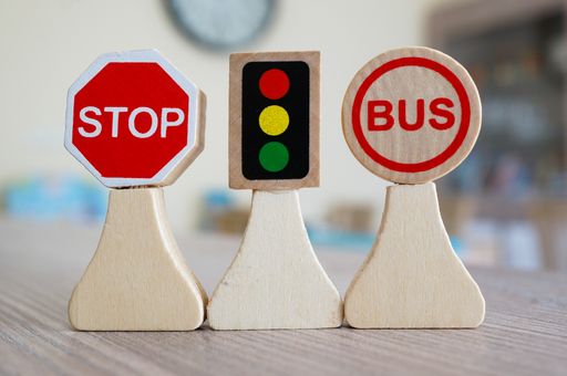 A closeup shot of miniature wooden road signs on a table