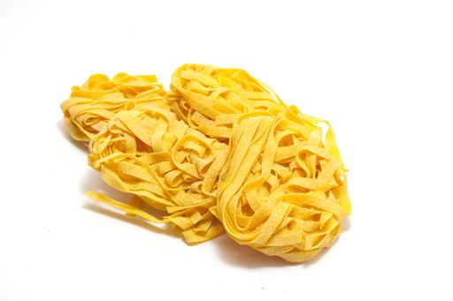 A closeup shot of Italian egg pasta rolled on a white isolated background