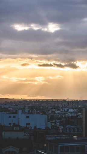 A vertical shot of a scenic sunset over the city in Paris, France