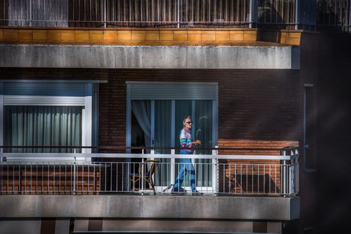People on balcony during COVID-19 confinement in Spain. Coronavirus Social Distancing. April 2020