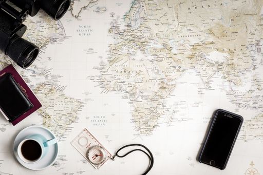 A high angle shot of travel items on a map