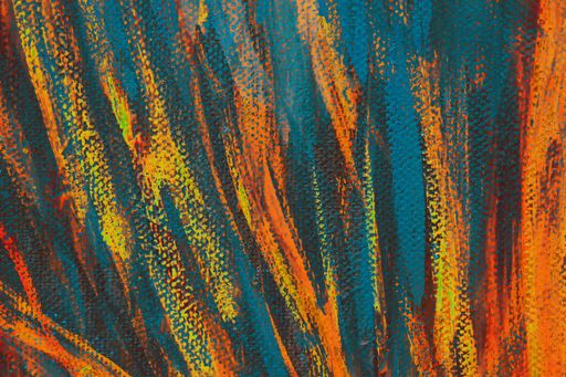 A closeup of an abstract multicolour painting on canvas under the lights