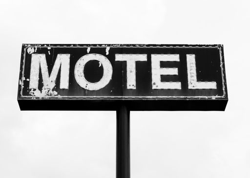 A closeup shot of a motel signboard isolated on a white background