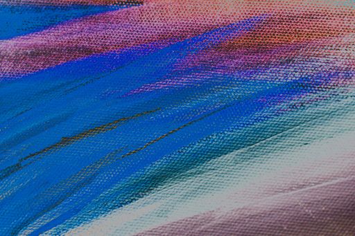 A closeup view of a colorful painting on a rough surface - concept: the colorful life