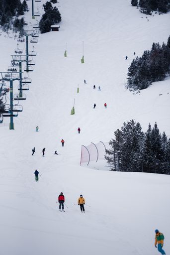 A vertical shot of a bunch of people skiing in the Grandvalira, Pyrenees