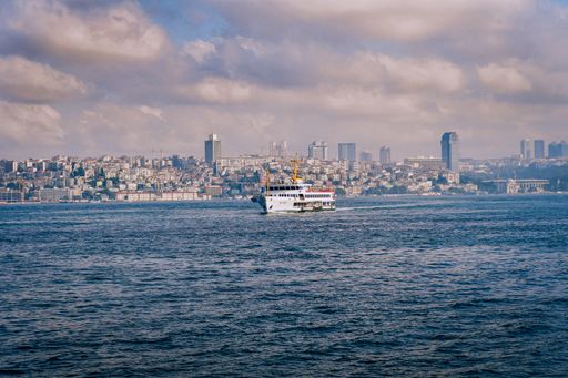 The mesmerizing view of the ship in Bosphorus with buildings in the background in Istanbul, Turkey