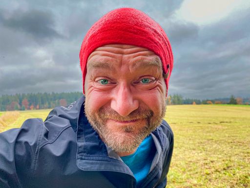 Running Man with red cap in close up view with nature background