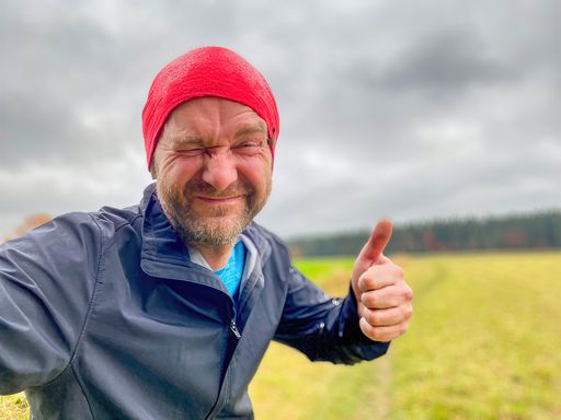 Running Man with red cap in close up view with nature background