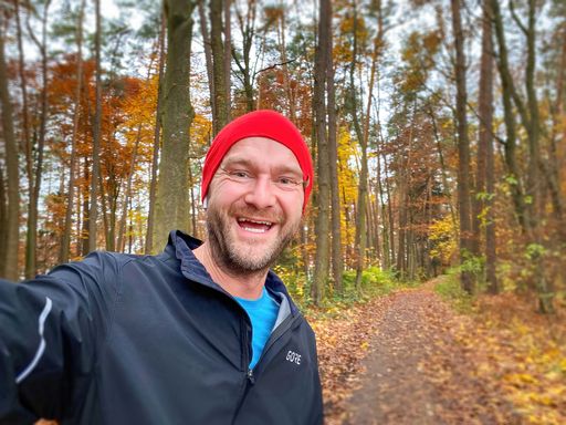 Running Man with red cap in close up view with nature background