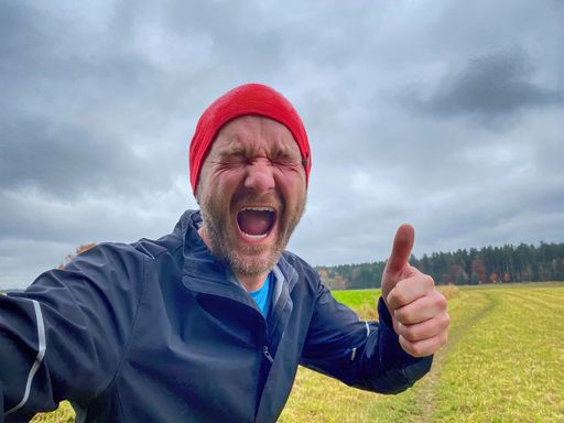 Running Man with red cap in close up view with nature background