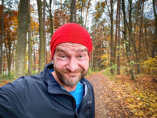 Running Man with red cap in close up view with nature background