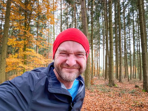 Running Man with red cap in close up view with nature background
