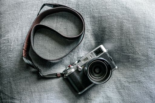 A top view of a vintage camera on a grey fabric surface