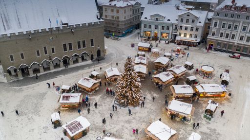 Aerial view to the historic Tallinn old down hall and square with the seasonal Christmas market