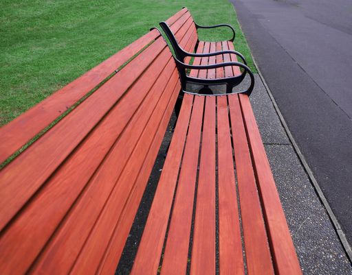 View of New wooden benches with black iron cast frame in park