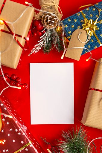 A red Christmas theme background with a blank card