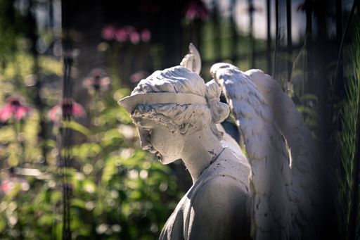 A closeup shot of a white female angel sculpture