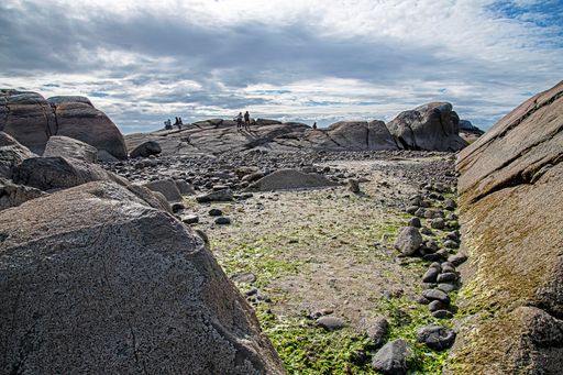 A beautiful view of people on a rocky beach in Chilean Patagonia