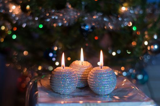 A closeup of decorative Christmas candles on a blurred background