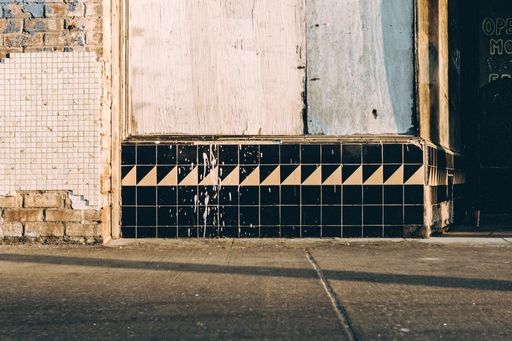 A wide shot of a ceramic textile wall on the street
