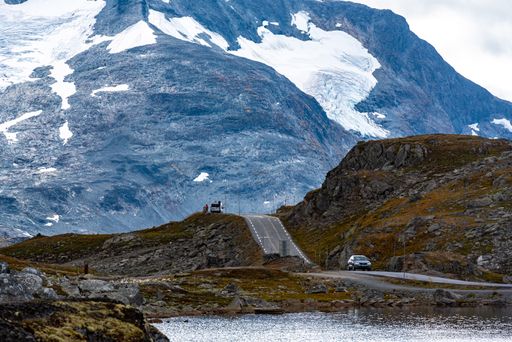 A beautiful shot of a rural road through frozen mountains near a river