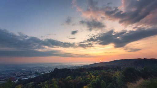 A beautiful view of a foggy town and mountains