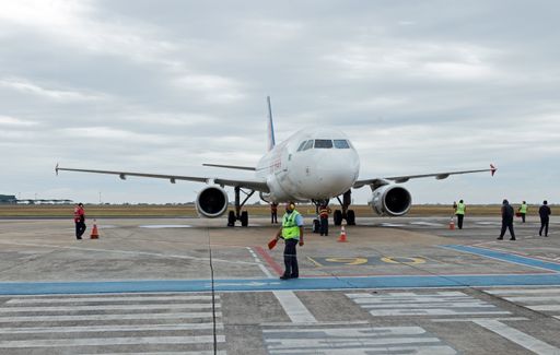 LATAM Airbus just arrived at the airport, the airplane guider walks away (with a funny expression on his face).