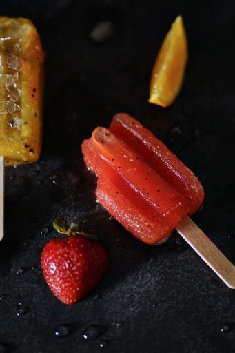 A closeup of delicious mango, passion fruit, strawberry and orange icepops