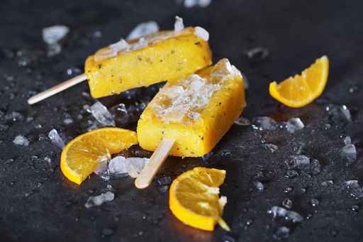 A closeup of delicious mango, passion fruit, strawberry and orange icepops