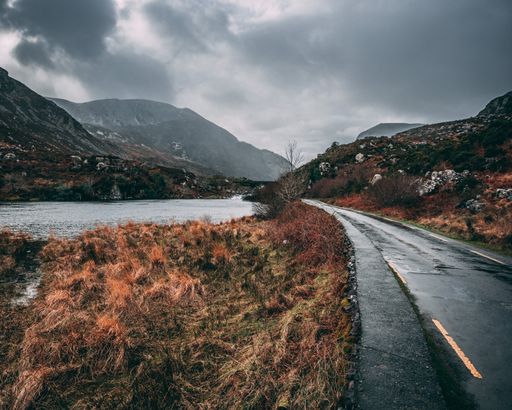 The view of the empty rural road on a moody day. Gap of Dunloe, County Kerry, Ireland.