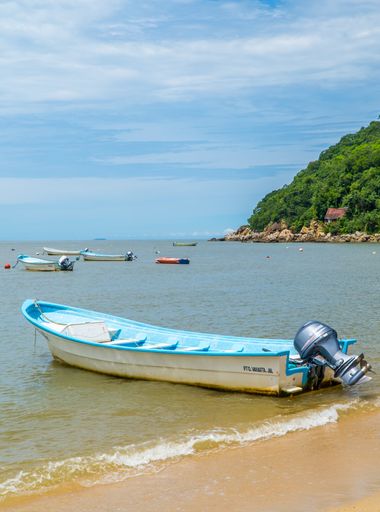 A closeup of small boats in the remote jungle beach town of Yelapa, Jalisco