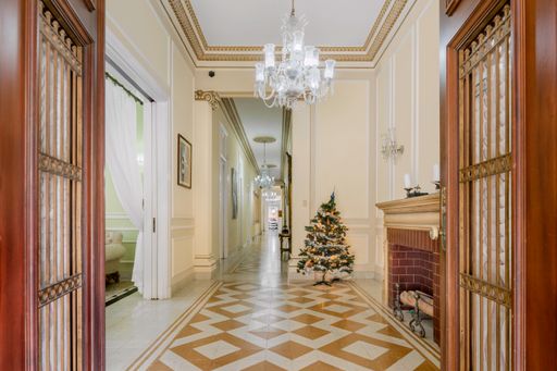 An interior in a house with classical architecture and chandelier lamps