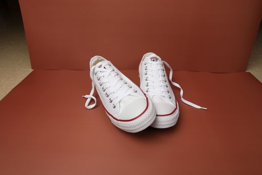 A closeup shot of a couple of converse shoes being shot in a studio in China