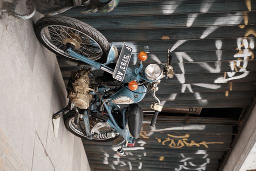 A closeup of a classic bike parked on a sidewalk