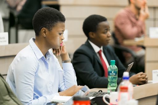 Diverse adult delegates attending a business lecture in a classroom